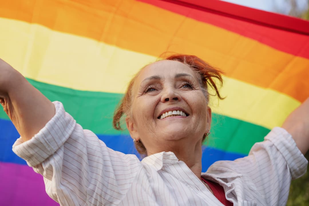Beautiful,Mature,Woman,With,Charming,Smile,Holding,Rainbow,Lgbt,Flag