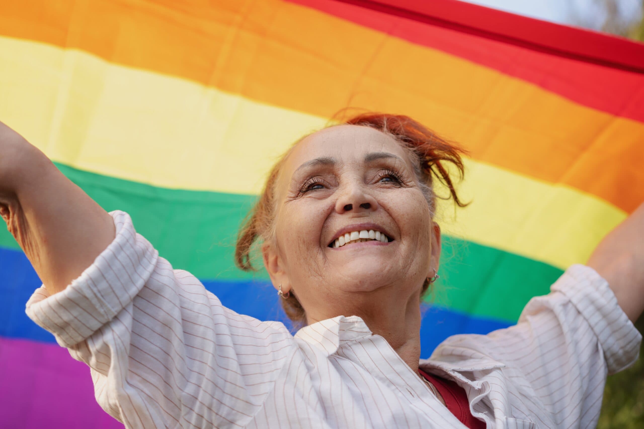 Beautiful,Mature,Woman,With,Charming,Smile,Holding,Rainbow,Lgbt,Flag